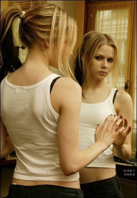 Avril looking into mirror