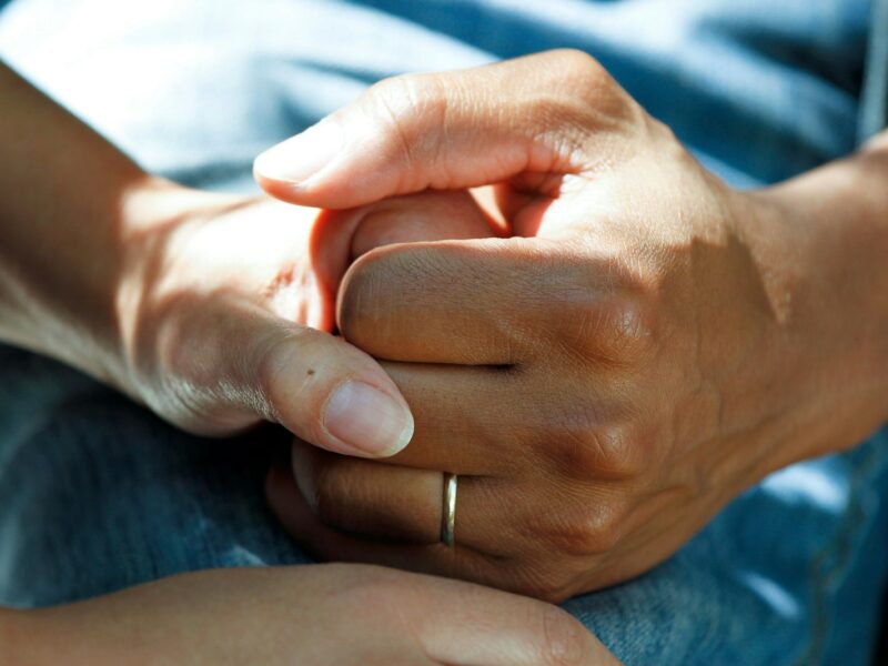 person wearing gold wedding band