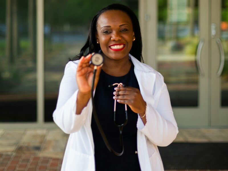 a woman holding a stethoscope in her right hand