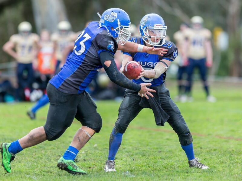 time-lapse photography of men playing football in field
