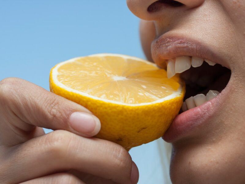 person holding orange fruit during daytime