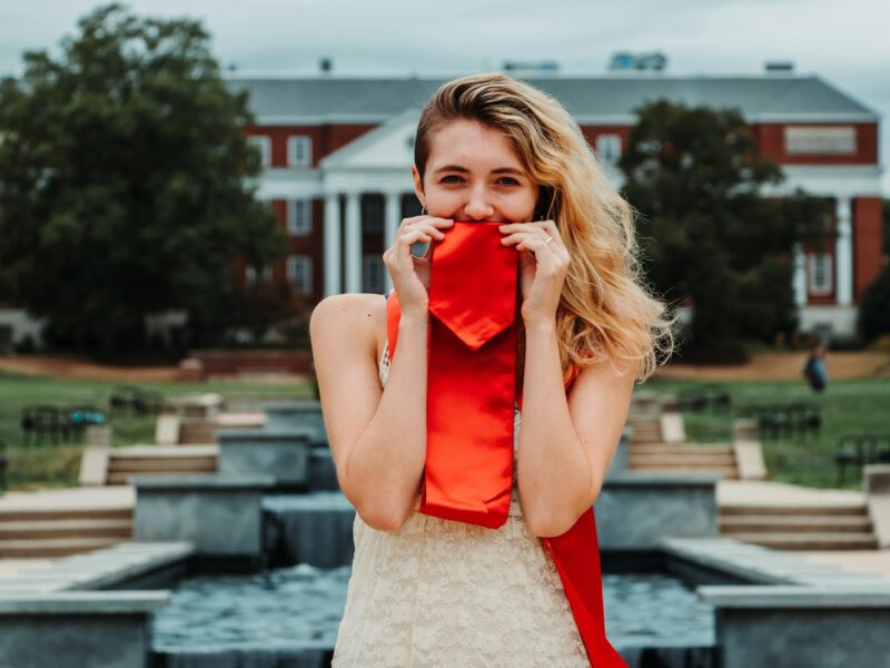 woman wearing red and beige sleeveless dress