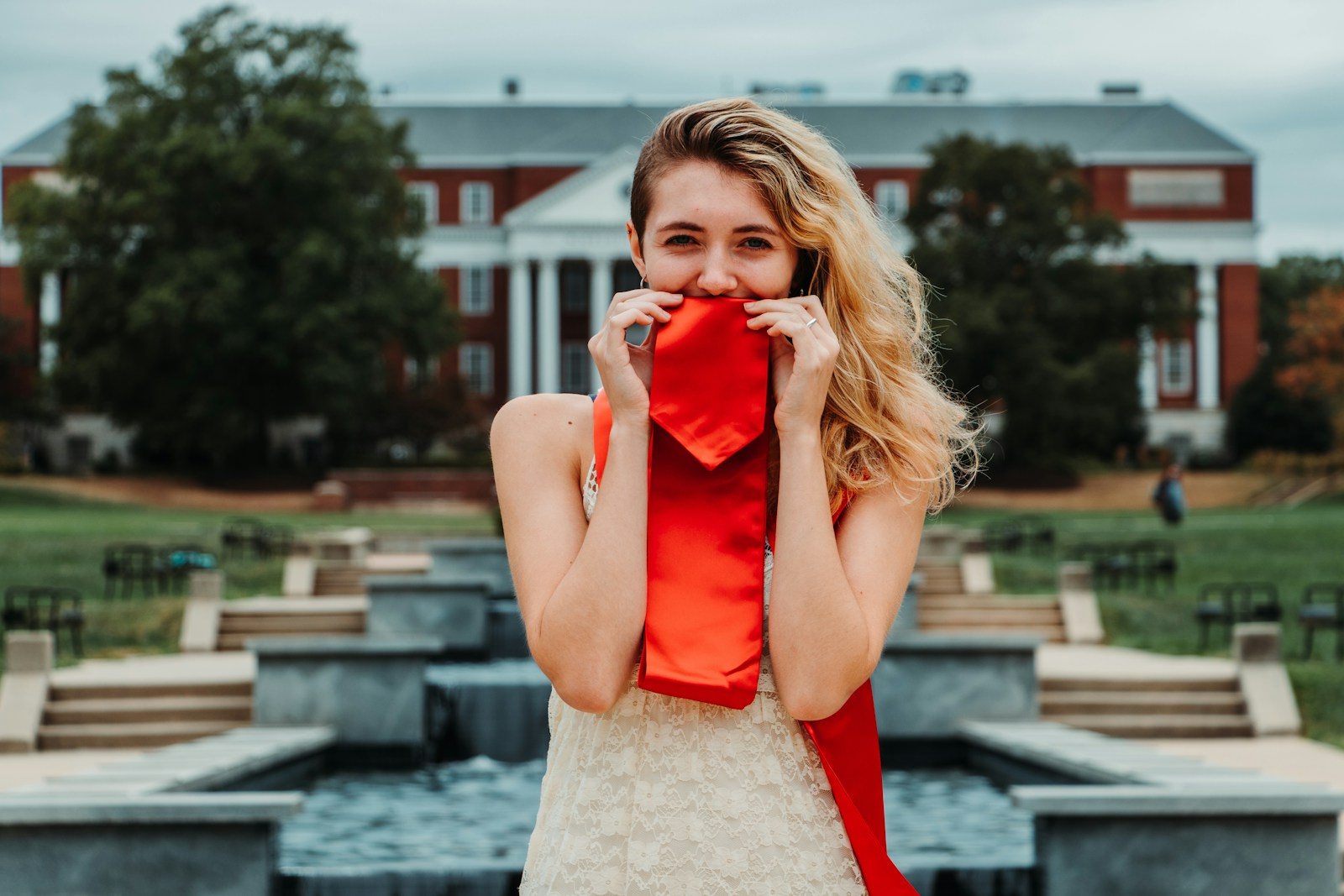 woman wearing red and beige sleeveless dress