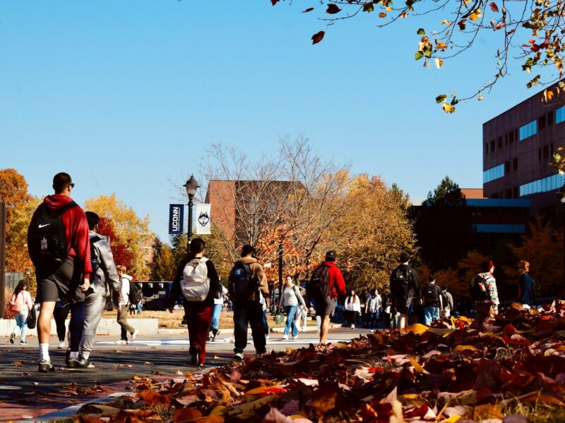 A group of people walking down a street